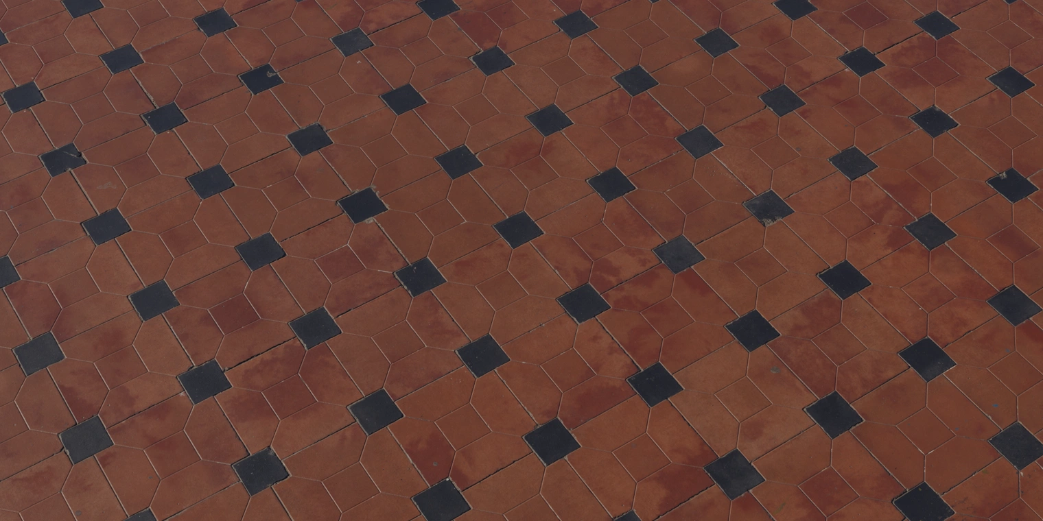Free 8K terracotta tile texture with an octagon-and-dot pattern, warm red slabs with small black insets, slight sheen, worn edges and fine grout lines.
