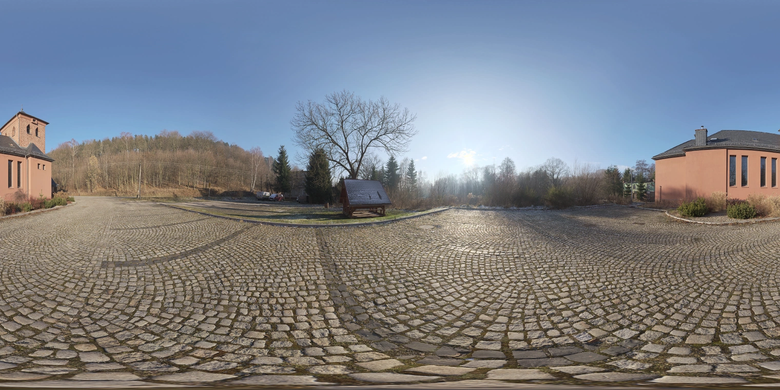 Free 29k unclipped HDRI of a clear autumn morning: low sun, high-contrast warm highlights on red church and cobbles, cool shadows from bare trees and pavement.