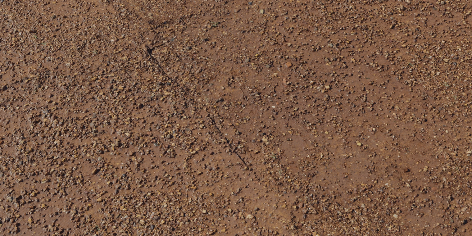 Free 8K texture of compacted red-brown mud with scattered gravel, a rough pebbly surface, damp sheen, and worn pathway detailing.