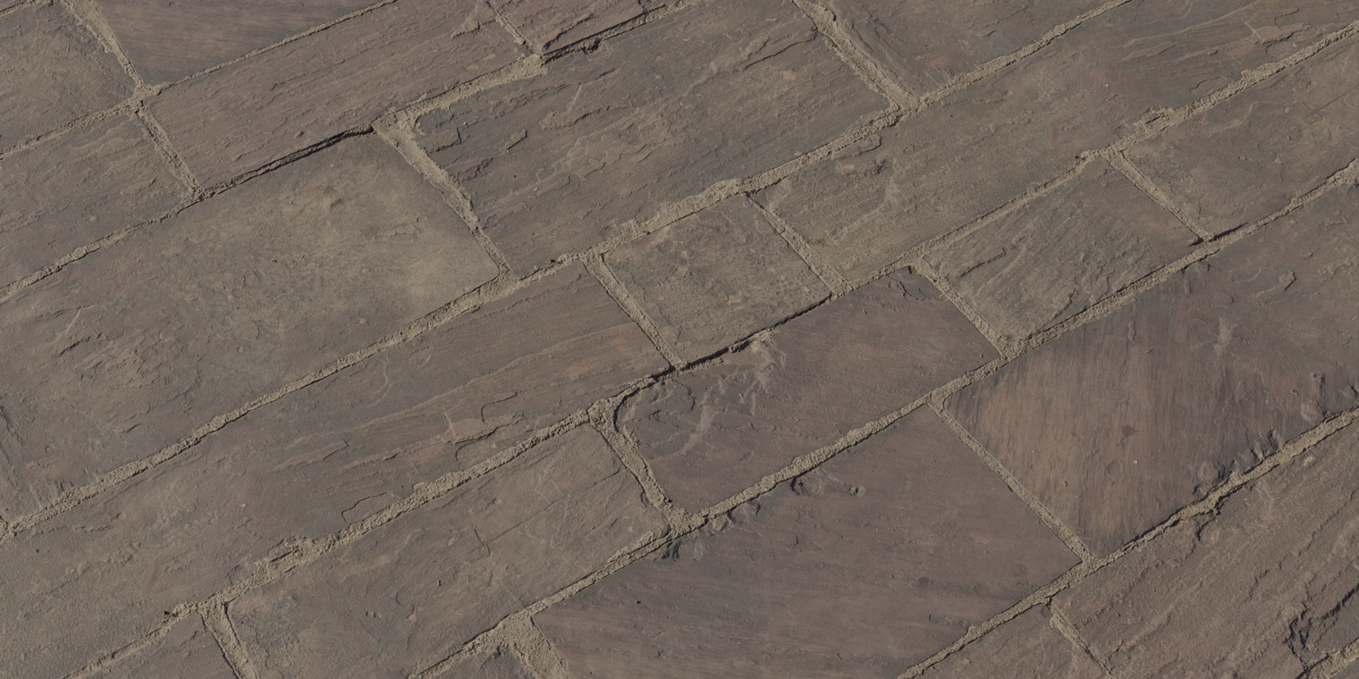 Free 8K texture of red sandstone pavement with weathered, discolored blocks, rough grain and eroded mortar joints, showing grit, dirt and muted red-brown-grey tones.
