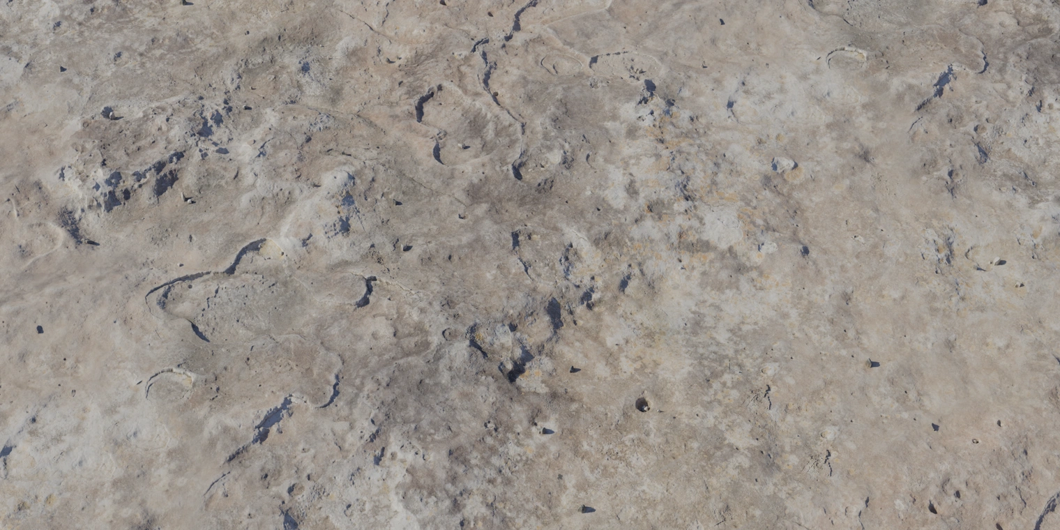 Free 16K texture of a dry, weathered rock boulder with rough, chipped and cracked surfaces, small pits and uneven, eroded pale sandy-gray tones.