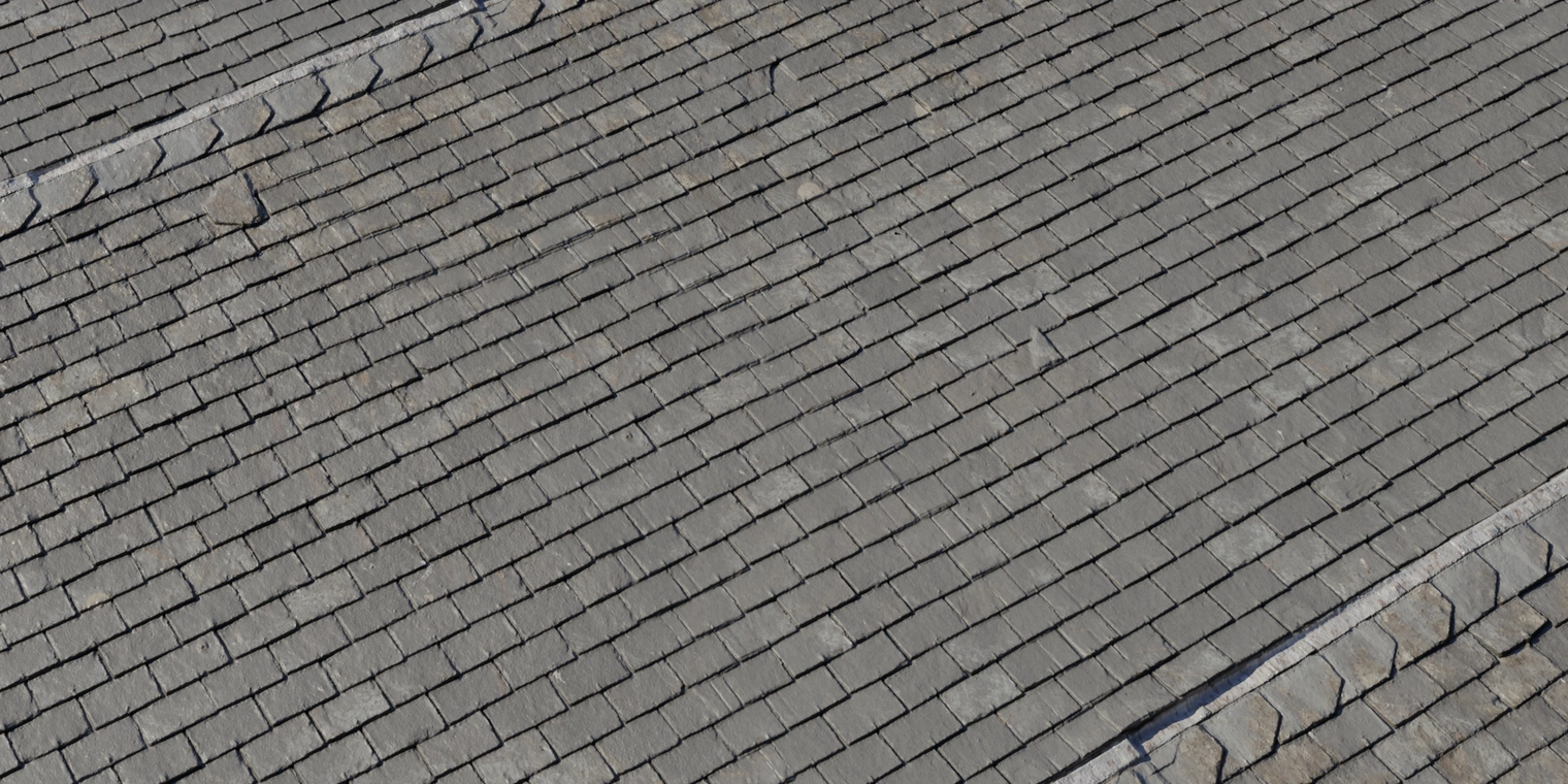 Free 8K texture of traditional overlapping slate roof tiles, even aged gray slates with chipped edges, subtle dirt and a rough stone surface with low sheen.