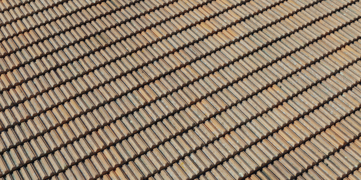 Free 16K texture of weathered terracotta roof tiles: overlapping ceramic tiles with chipped edges, dirt streaks and subtle mossy patina, rough.