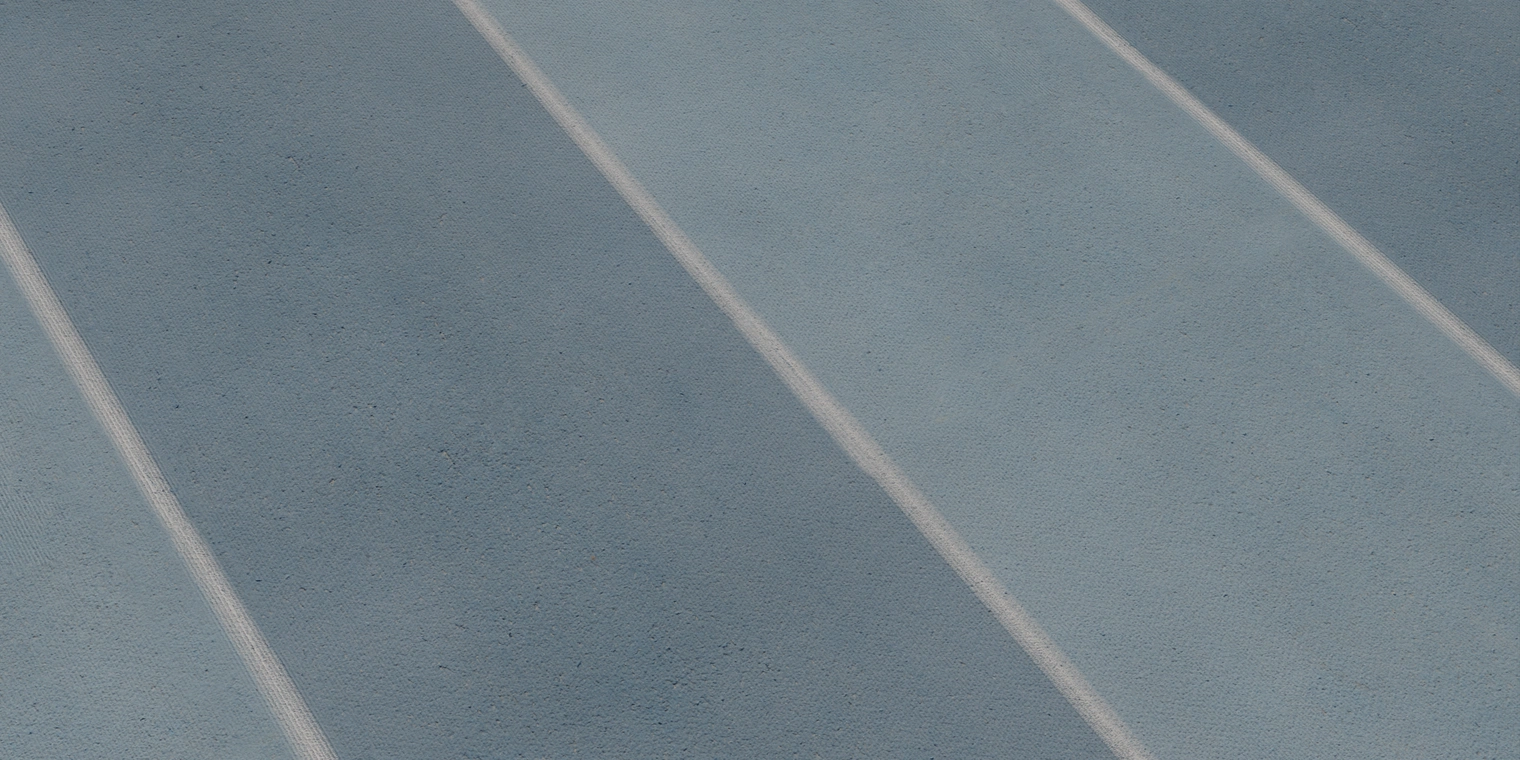 Free 8K texture of a faded blue rubber running track with worn white lane lines, subtle granular roughness and matte scuffed surface.