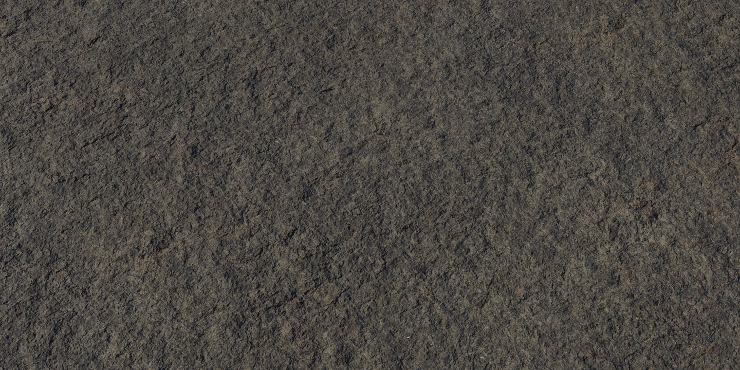 Free 8K texture of weathered seaside rock, rough, solid cliff face in dark gray-brown with pitted, eroded grain and subtle coastal wet sheen.
