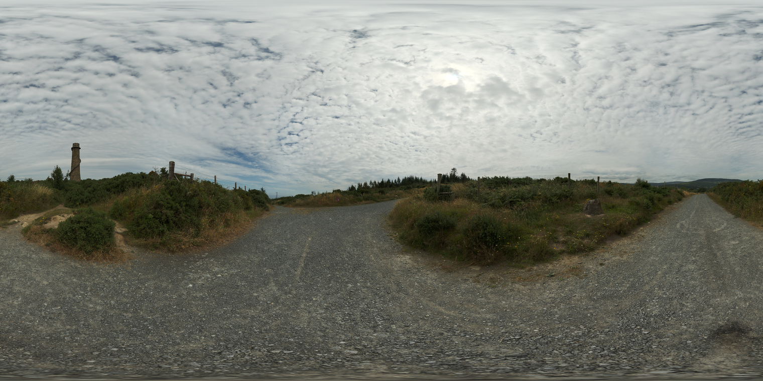 Free 20K unclipped HDRI: soft midday, low-contrast natural light on gravel road, bushes and a ruined stone tower. Great for outdoor renders and archviz.