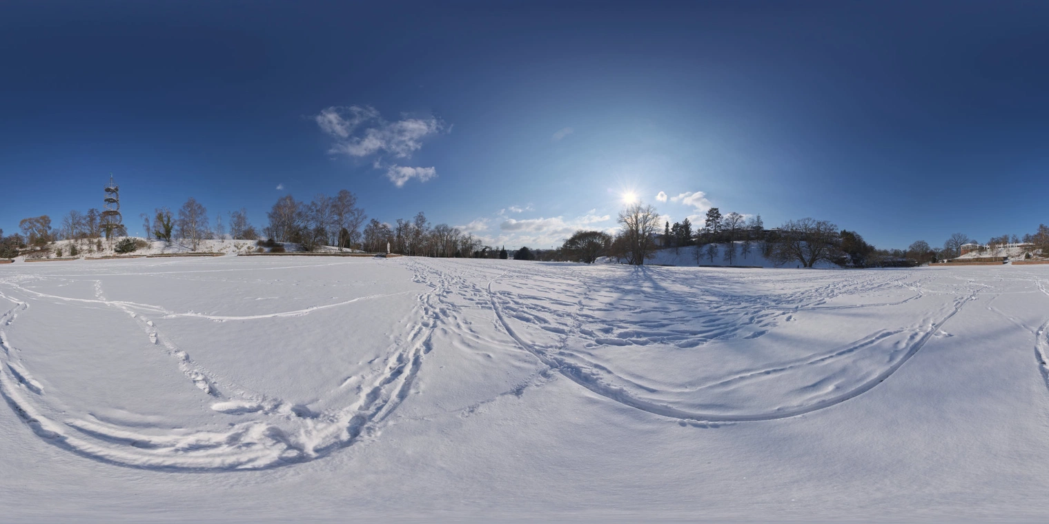 Free, unclipped 19K HDRI of a snowy field: bright, high-contrast winter afternoon sun, deep blue partly-cloudy sky, long cool shadows and crisp snow.