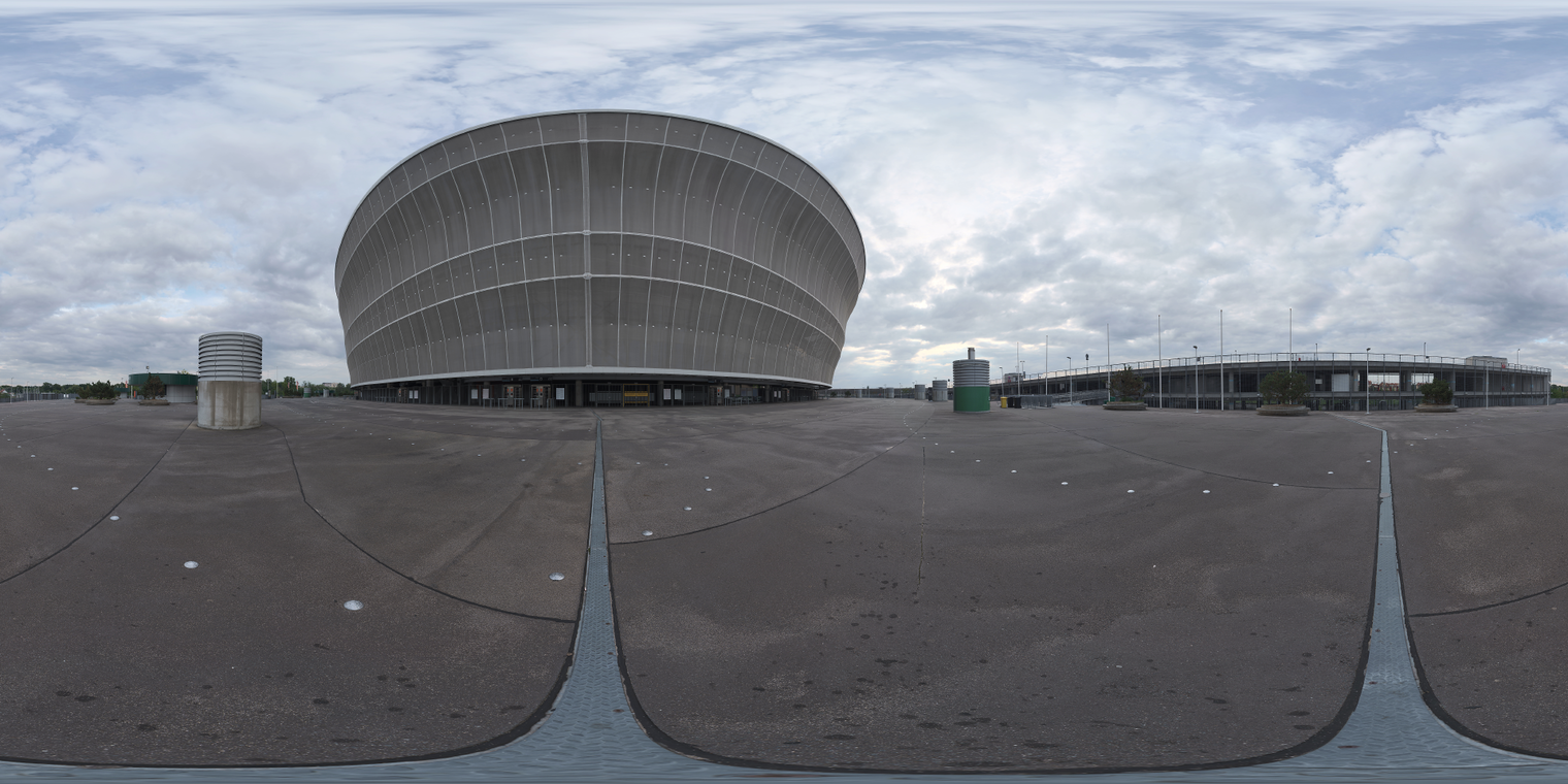 Free 29K HDRI, unclipped: soft low-contrast morning-afternoon overcast light on a concrete stadium plaza with parking and vents, ideal for urban renders.
