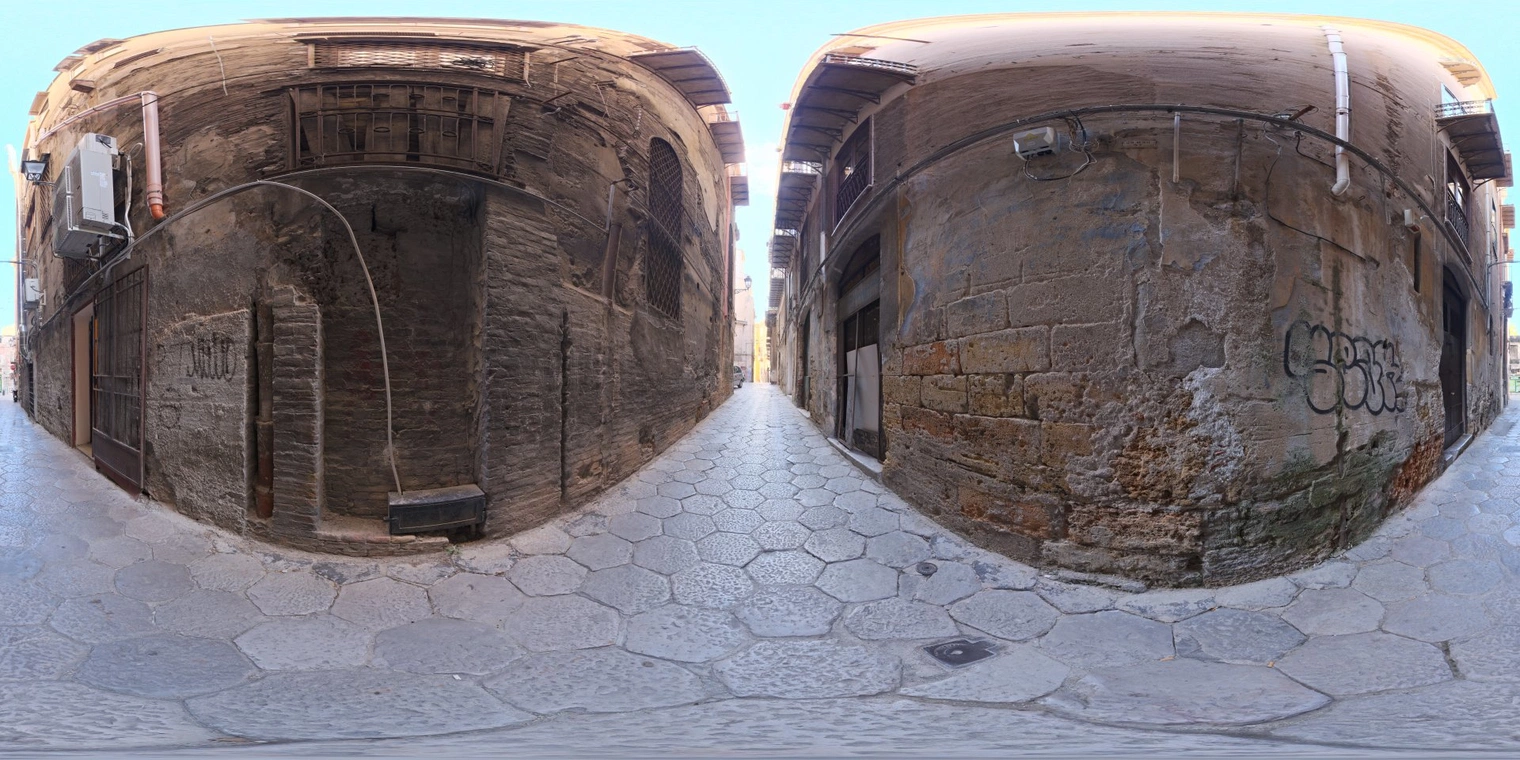 Free 20K unclipped HDRI of a narrow European cobblestone alley with brick walls - warm sunlit end, cool shadows and medium-contrast natural light.