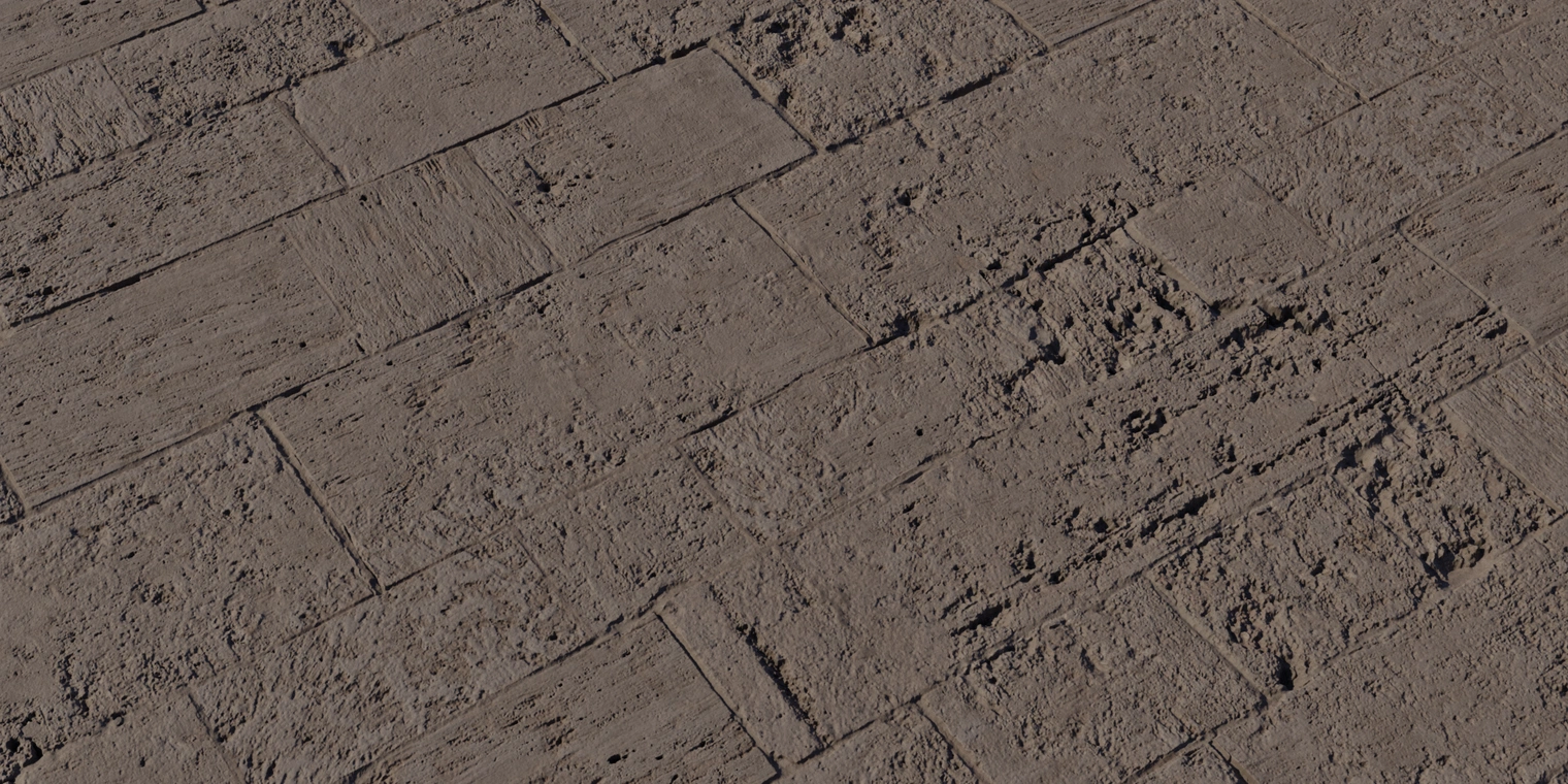 Free 8K stone wall texture showing rough, brown, weathered blocks with chipped edges, cracks, surface pitting and dirt-filled mortar for an aged, damaged look.
