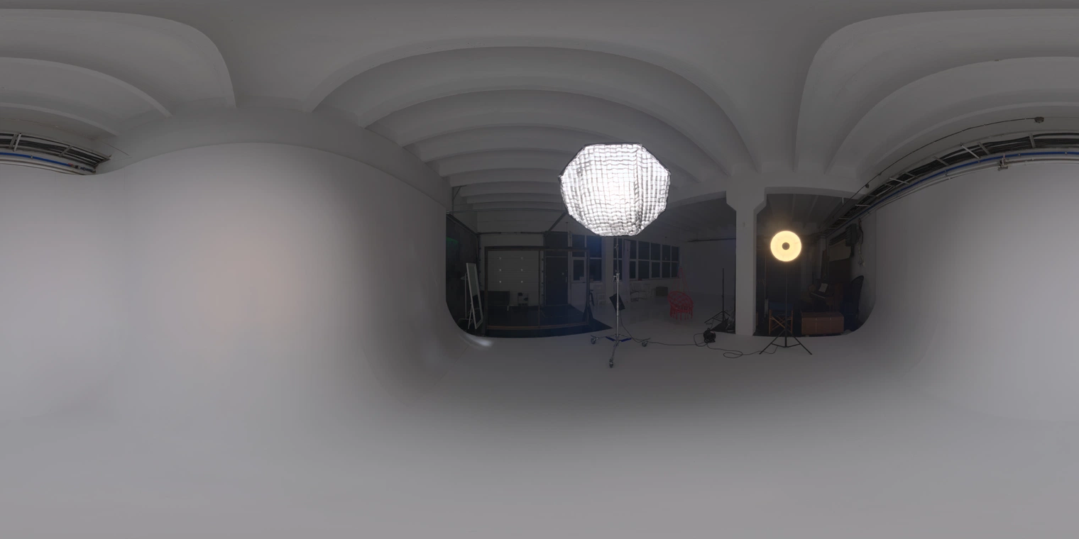 Free, unclipped 20K HDRI - warm indoor studio with soft umbrella key and a lamp rim, medium contrast and infinity cyc walls; great for product, portrait, and urban studio renders.