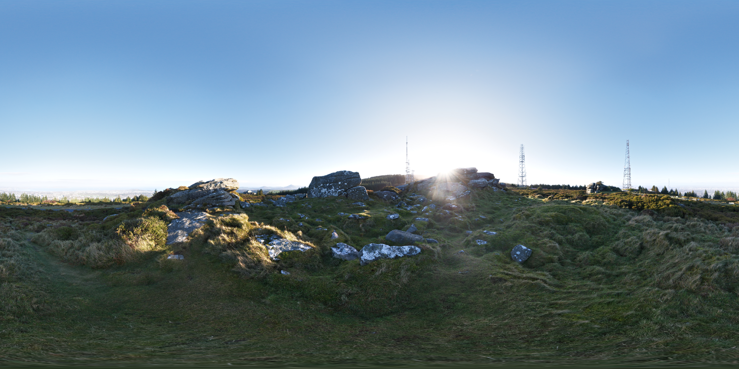 Free 20k unclipped HDRI featuring a low sun over rocky, grassy moorland, warm backlight with strong lens flare, cool blue ambient light and pronounced long shadows.