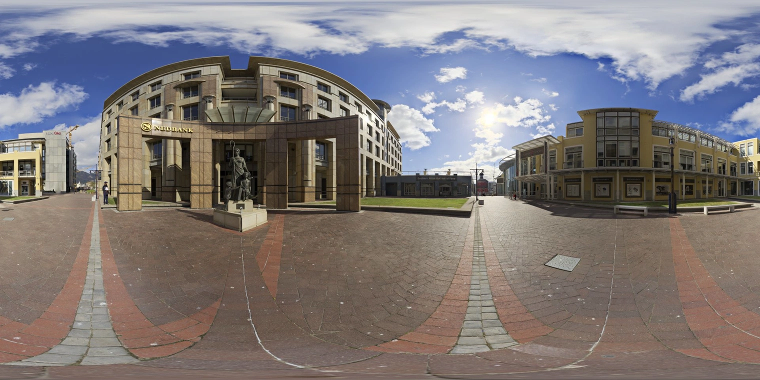 Free 16K unclipped HDRI: urban courtyard with bright morning/afternoon natural light, partly cloudy sky, high-contrast shadows and building reflections.