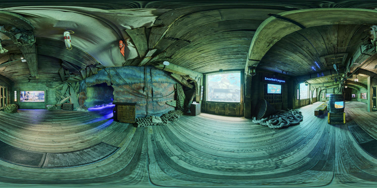Unclipped, free 24K HDRI of a dim wooden aquarium hall. Teal tank glow gives a cool, moody ambiance with soft highlights.