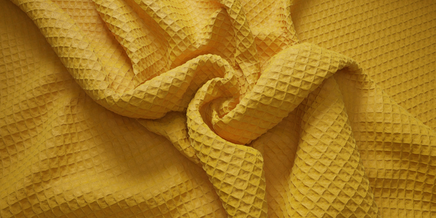 Free 8K texture of yellow waffle-pique cotton with pronounced grid, soft matte surface and recessed squares - great for textiles, linens, apparel and props.