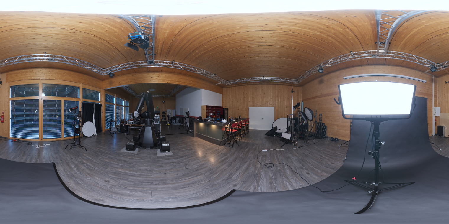 Free unclipped 24K HDRI of a wooden studio with warm ceiling, soft rectangular key and dark floor - mid-contrast studio light ideal for product viz & portraits.