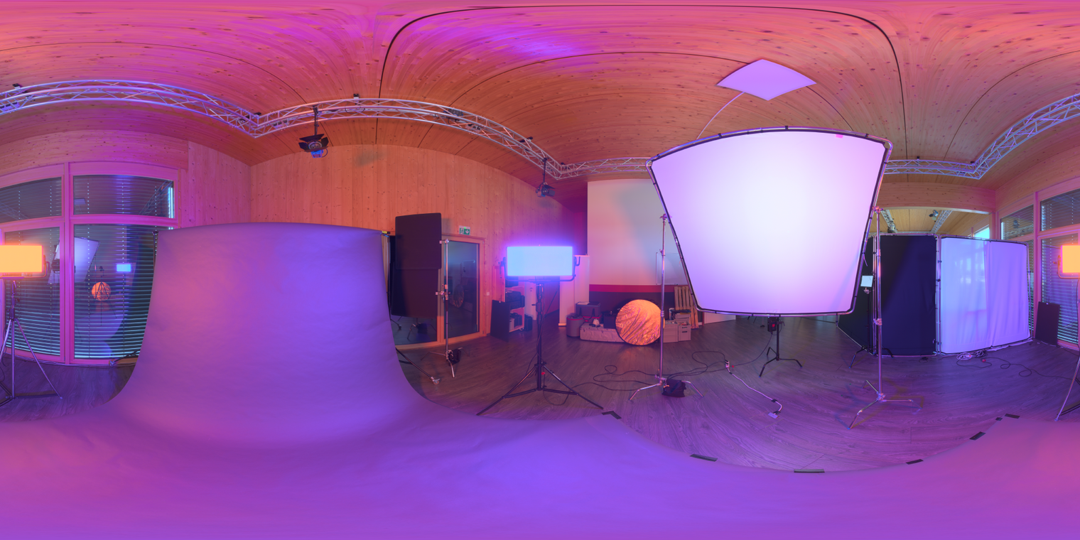 Free unclipped 24K HDRI of a wooden studio with warm orange and cool blue lights; large softbox, black-floor reflections and high-contrast indoor lighting.