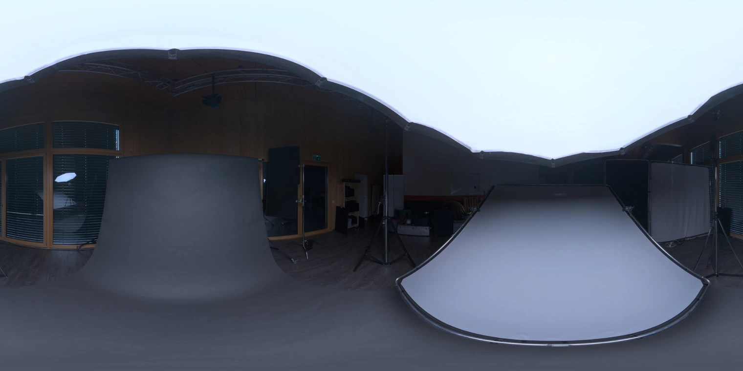 Unclipped, free 24K HDRI: soft overhead softbox with lamp fills, cool tone and black-floor reflections - ideal for product/portrait and high-contrast renders.