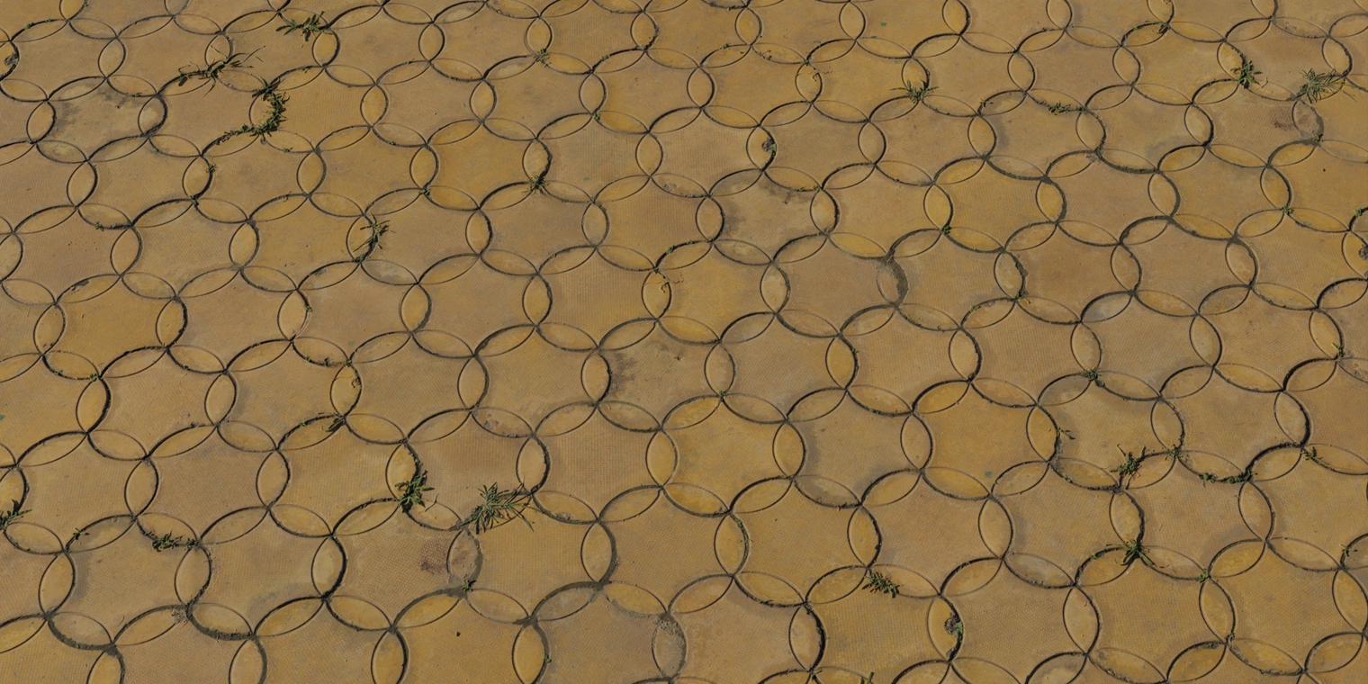 Free 16K texture of worn yellowish patterned concrete pavers with a unique rounded hexagonal pattern. Stained, weathered surface.