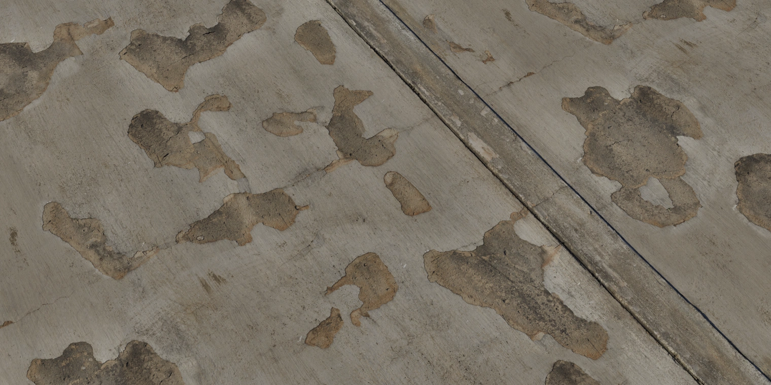 Free 8K texture of a worn plaster wall with uneven, rough, chipped plaster revealing concrete, cracks and crumbling weathered damage - perfect for aged, deteriorating surfaces.