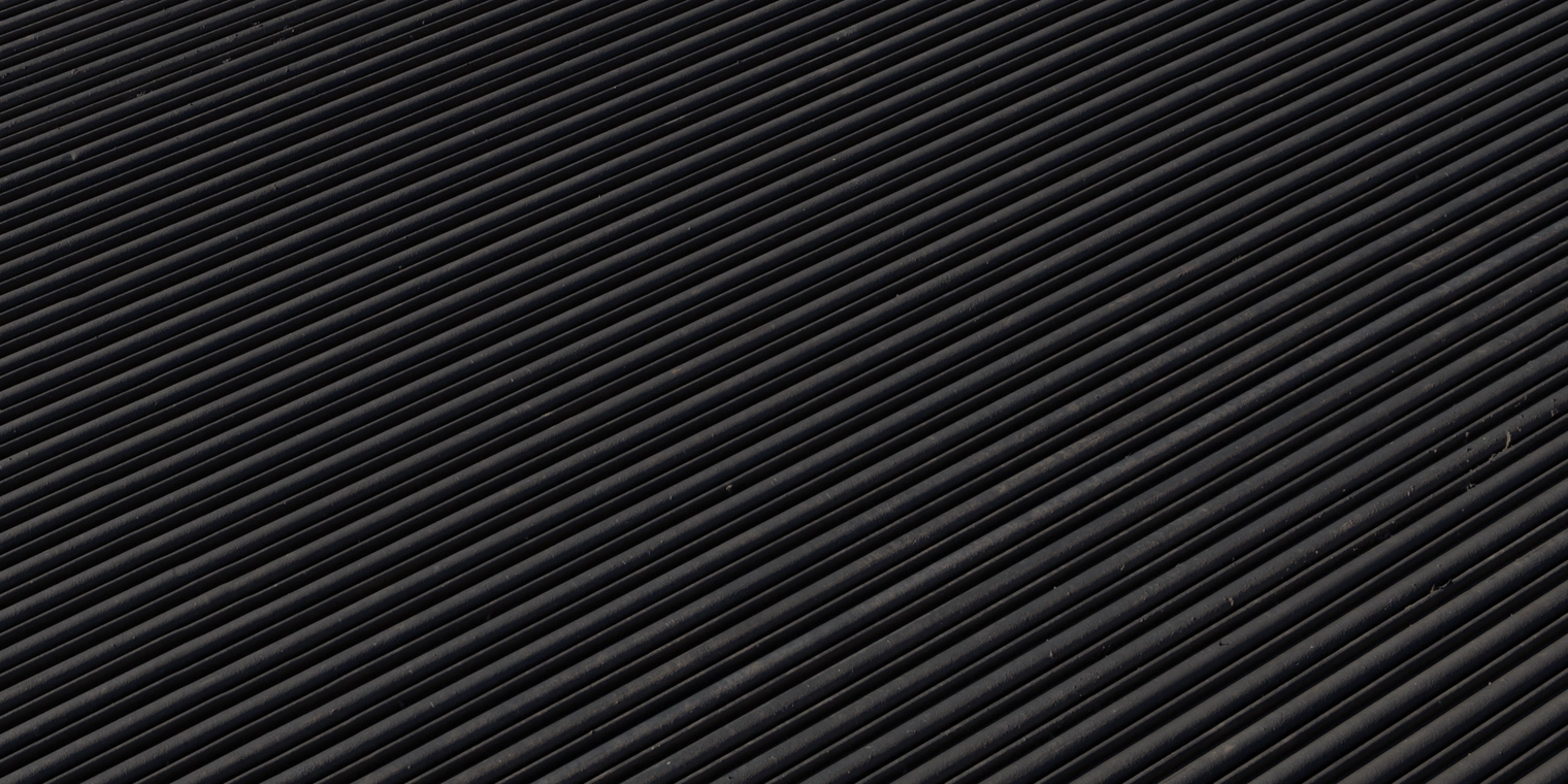 Free 8K texture of a weathered corrugated metal shutter with dark matte paint, fine scratches, edge wear and grime collected in the grooves.