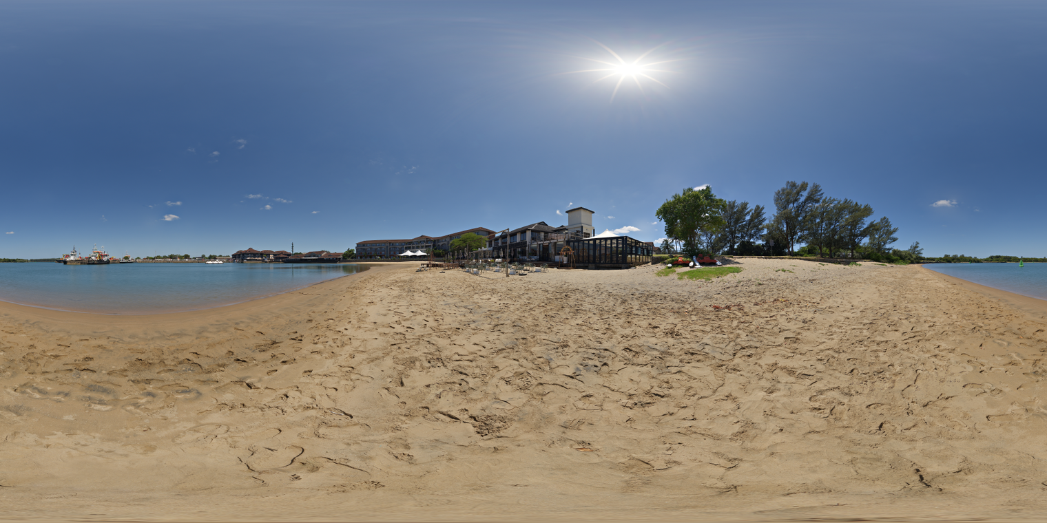 Unclipped, free 24K HDRI of a sunny beach: clear blue sky, sharp midday sun, hard shadows, warm sand and calm water, bright reflections, slight horizon haze.